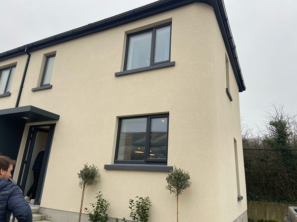 An outside view of a house printed using 3D concrete technology.