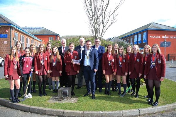 Council Chairperson, Councillor Pete Byrne presents a crystal bowl to Under 16 Captain, Katie Niblock, to acknowledge their victory in the Ulster Championships. Also photographed are Councillors Henry Reilly and Glyn Hanna and Conor Haughey, NMDDC Assistant Director Healthy Living with the U16 Hockey Team.