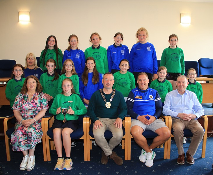 NMDDC Chairperson, Councillor Philip Campbell hosted a Civic reception in honour of Dromintee Primary School Girls football team, which won the Malachy McGeeney Cup in the Medium Schools A competition. The Chairperson is pictured with the players as well as front from left: Principal Wendy McKeown; team captain, Niamh Harris; Oliver Gaughran and Councillor Mickey Larkin. 