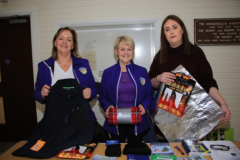 Margaret McGuire and Teresa Nugent from the Rural Health Partnership, show Slieve Gullion District Electoral Area (DEA) Form co-ordinator Aoife McComiskey (right), the contents of goodie bags which were presented to those who attended the event.