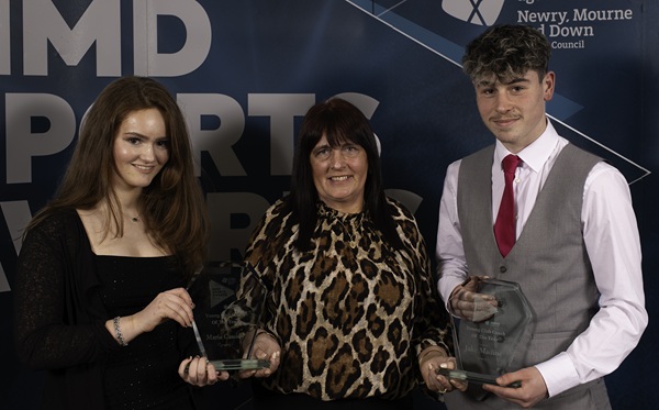 Maria Cassidy, Newry Rowing Club and Jake Medine, Ballynahinch Olympic FC, joint winners of Junior Club Coach of the year for 2024, being presented with their awards by Councillor Valerie Harte.