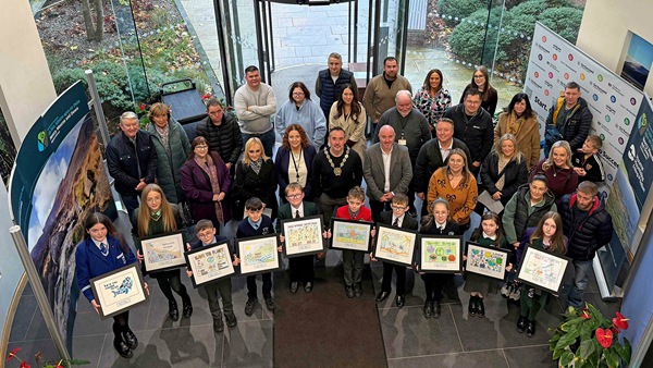 The 10 winners of the annual Newry, Mourne and Down District Council Schools’ Environmental Poster Competition with Newry, Mourne and Down District Council Chairperson, Cllr Philip Campbell, Council officials, teachers and parents in the foyer of the Council offices in Downpatrick.  