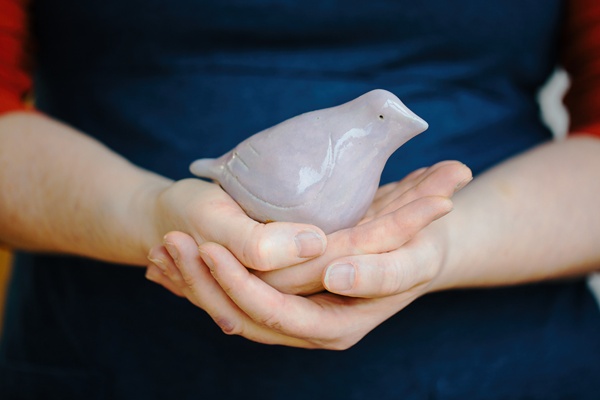 Anita Reynolds holds her bird in my hand creation
