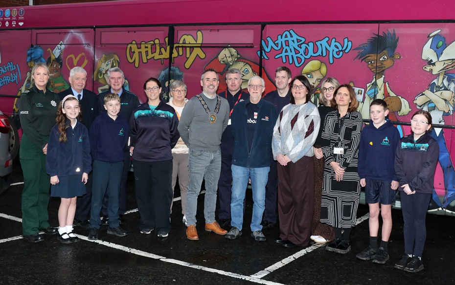 Newry, Mourne and Down District Council Chairperson, Cllr Philip Campbell is photographed at the Ballymore Centre in Downpatrick with representatives from a range of key organisations involved in delivering the BeeSafe initiative, including the PSNI, Translink, NIFRS, County Down Rural Community Network, RNLI, and the Council’s Health Improvement team as well as P7 pupils from the Cedar Integrated School in Crossgar.