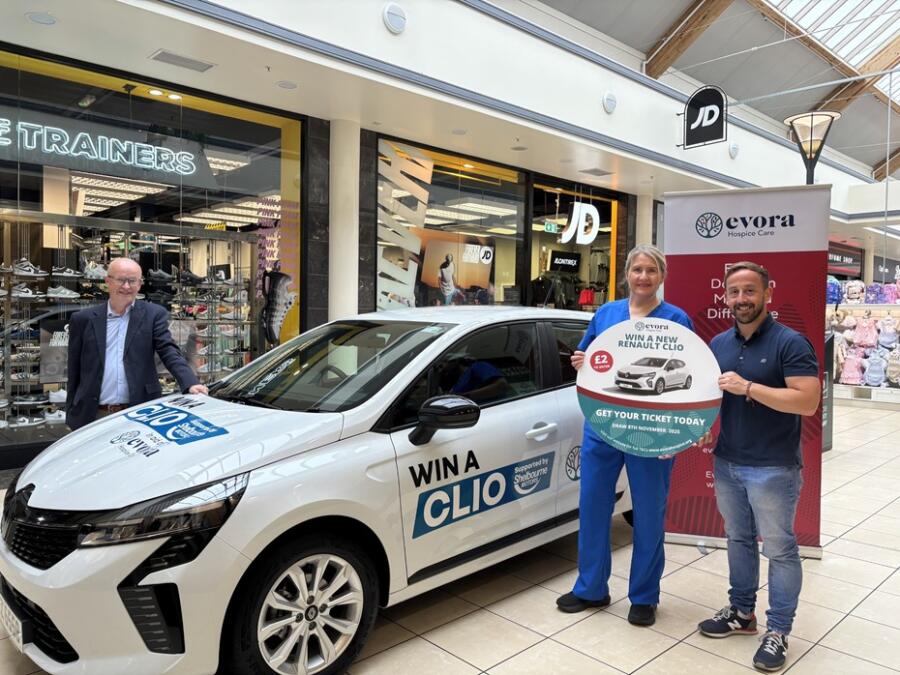 James McCaffery (Evora staff member), Vanessa Morton (Evora Hospice Staff Nurse) and Peter Murray (Buttercrane Centre manager) launch the 2025 Evora Hospice Care raffle.