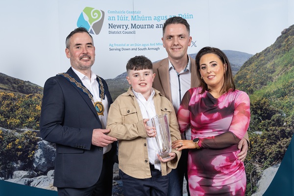 Chairperson Cllr Phlip Campbell is photographed with Cian McEvoy, the recipient of the Chairperson’s Special Award and his mum and dad, Gerard and Lauren McEvoy.