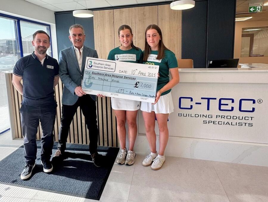 Katie and Anna receive a cheque for £7000 from Jimmy Walsh, CT1