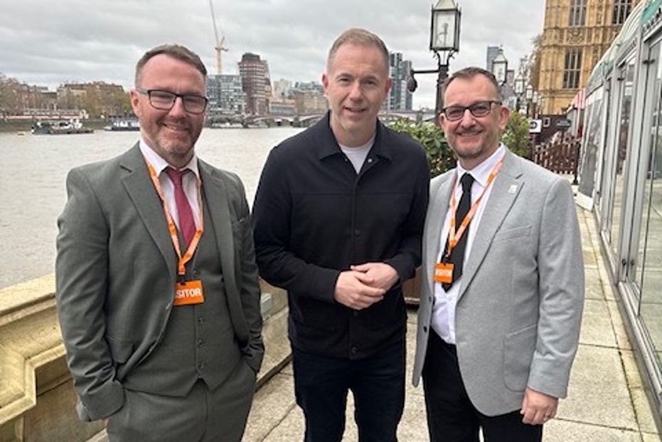 Rostrevor Men's Shed founder Mark Gibbons and Gethin Hughes with South Down MP Christ Hazzard in London