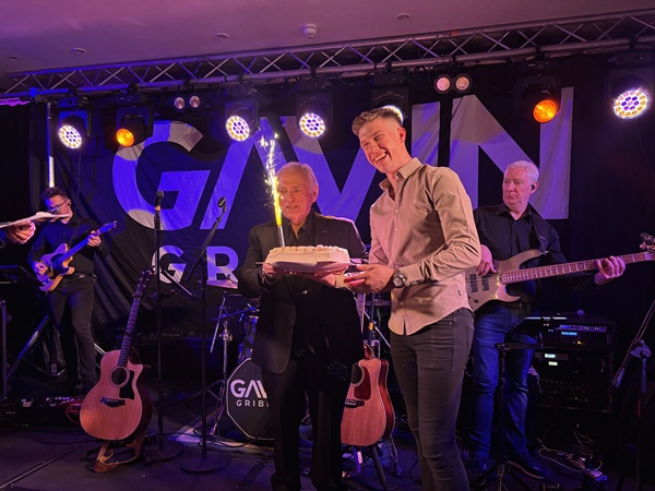 Gavin Gribben presents Hugo Duncan with a birthday cake.