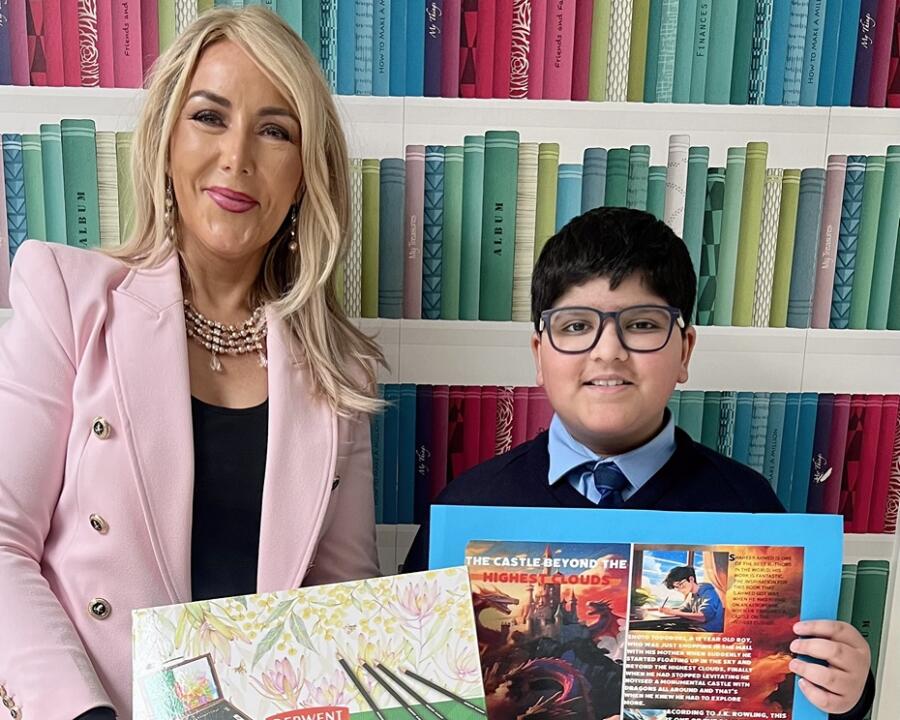 Shaheer Ahmed is pictured receiving his prize from St Malachy's Principal Miss Mary Creegan.