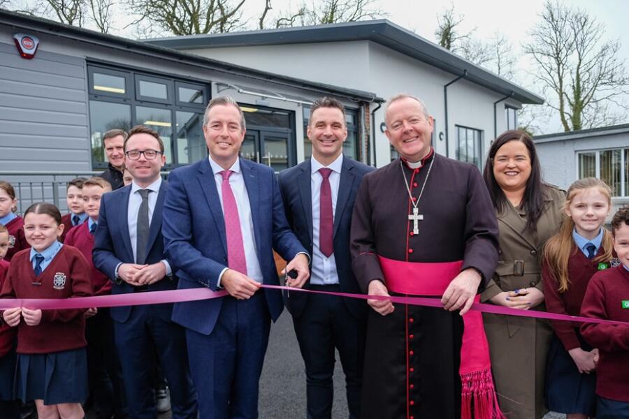 Education Minister Paul Givan pictured at the opening of new facilities at Foley PS with Principal Kieran McCrory, pupils, Archbishop Eamon Martin, Daire Hughes MP and Chair of Board of Governors Bronagh Haughey. 