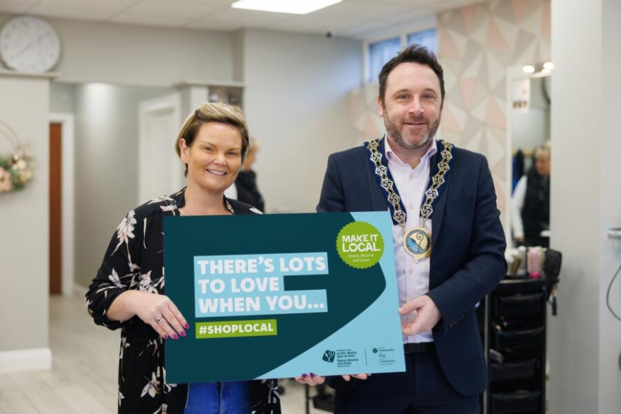 NMDDC Chairperson, Cllr Pete Byrne launches the new Make It Local campaign, ‘There’s Lots to Love when you #ShopLocal’. The Chairperson is photographed with Michelle Mallon from Michelle Mallon Hair & Beauty in Meigh, one of the villages and small towns which benefited from improvements to its infrastructure and public spaces through funding from the ‘Small Settlements Regeneration Programme’.