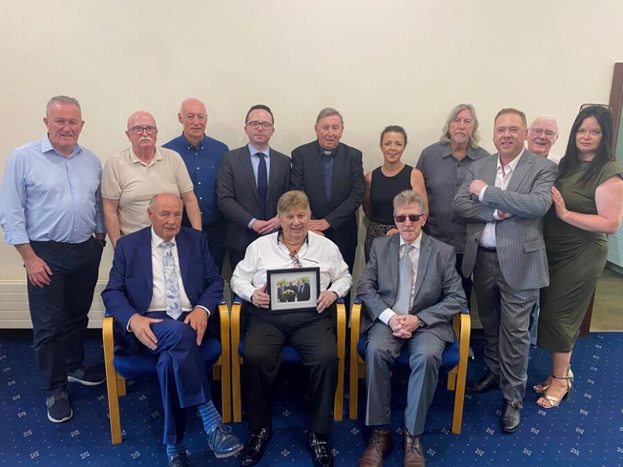 Brian Maguire, Miami Showband Road Manager and band members Des Lee and Stephen Travers (seated) with political representatives and Fr Brian D'Arcy and Eugene Reavey at Newry, Mourne and Down District Council Offices at Monaghan Row.