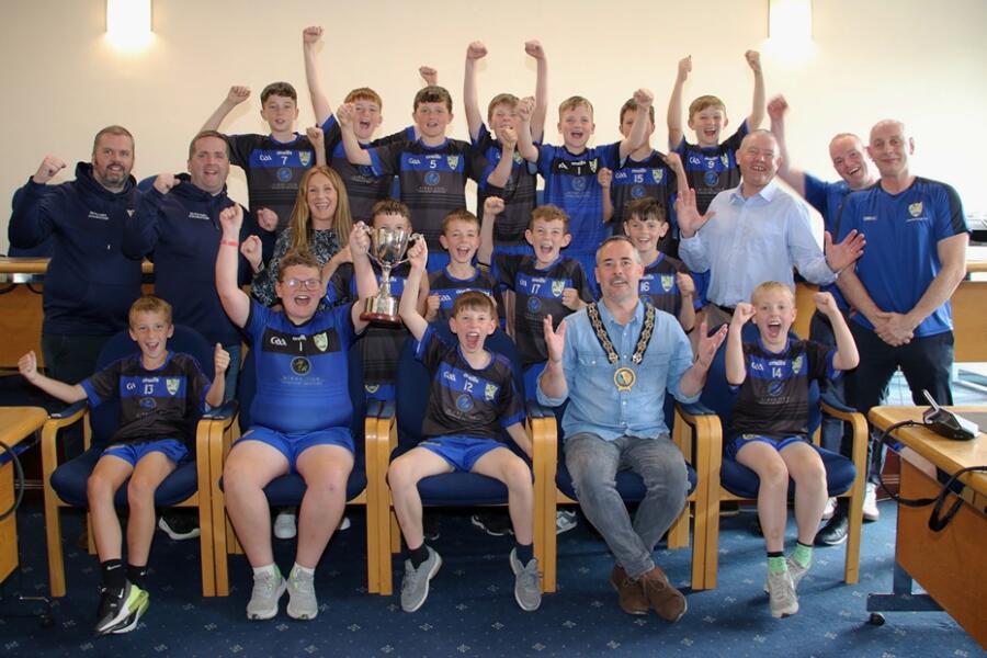 NMDDC Chairperson Councillor Philip Campbell is photographed with the players of Jonesborough Primary School boys football team along with, from left:  coaches, John McFearon, Eamonn Murphy; Acting Principal, Marion Litter; Councillor Mickey Larkin and Coaches Philly McEvoy and Declan McCoy, at a Civic reception to recognise their achievement in winning the Malachy McGeeney Cup in the Small Schools competition.