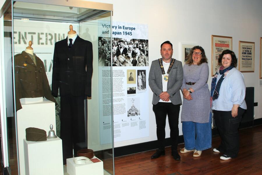 Pictured at the recent launch of the VE Day and VJ Day Exhibit are Joanne Cummins Collections Officer, Newry and Mourne Museum with Newry, Mourne and Down Council Chairperson, Councillor Pete Byrne and Shan McAnena Curator Newry, Mourne Museum. They are standing next to the display of the uniform of PFC James Quinn, a local man from near Kilkeel who served in the Allied advance into Germany after the D-Day landings and a Burton suit (demob suit) belonging to James Murphy also of Kilkeel, who served in North Africa with the Royal Army Ordnance Corps. Photograph: Liz Boyle