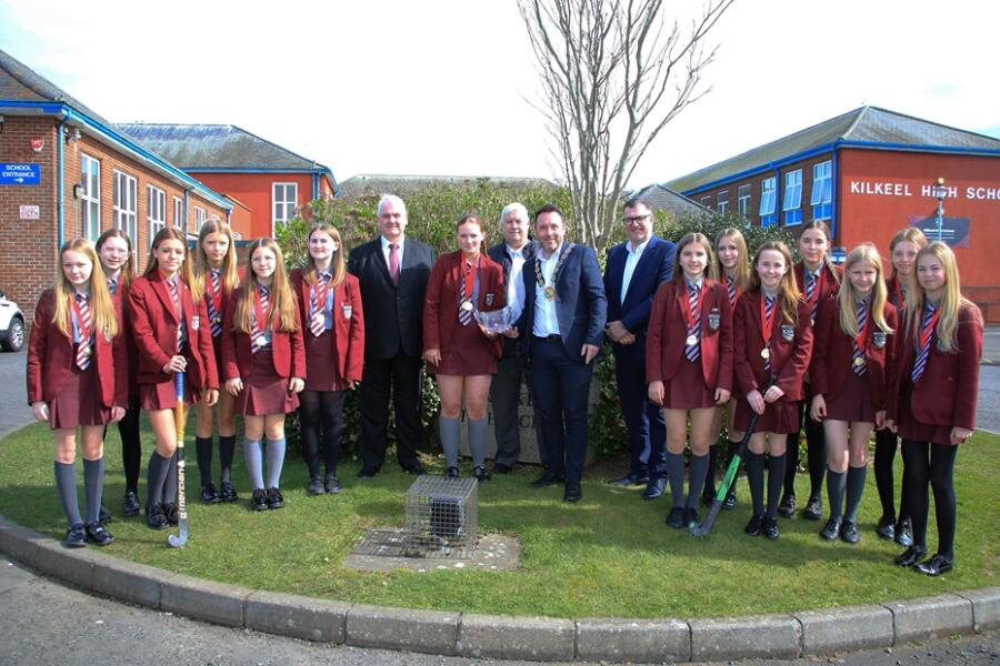 Council Chairperson, Councillor Pete Byrne presents a crystal bowl to Under 14 Captain, Carly Houston, to acknowledge their victory in the Ulster Championships. Also photographed are Councillors Henry Reilly and Glyn Hanna and Conor Haughey, NMDDC Assistant Director Healthy Living and the U14 Hockey Team.