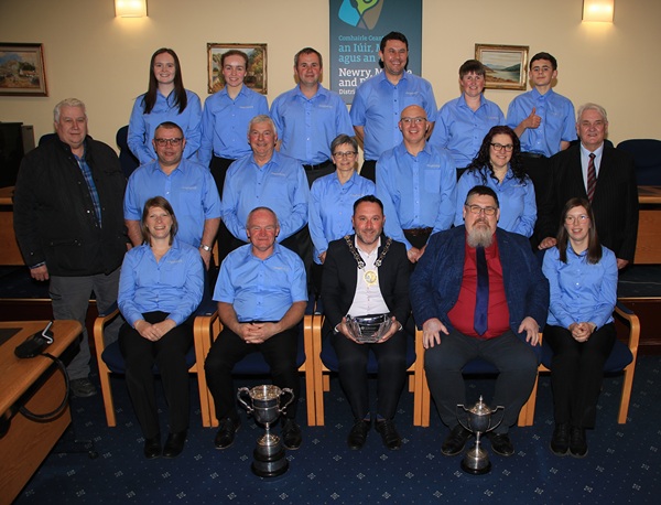 Council Chairperson Councillor Pete Byrne is photographed with members of the Orangefield Flute Band including (front row) Band Chairperson, Gordon McKee (left of Council Chairperson), Alan Trimble, Band Conductor (right of Council Chairperson) and Sandra Hanna, Band Vice Chairperson (far right). Also photographed are Cllr Glynn Hanna and Cllr Henry Reilly.