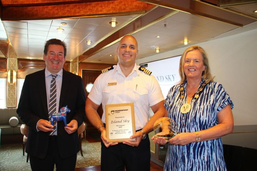 Newry, Mourne and Down District Council Deputy Chairperson, Councillor Geraldine Kearns presents Captain Jose Fonseca with a plaque to mark his visit to Warrenpoint alongside David Holmes, CEO Warrenpoint Port.