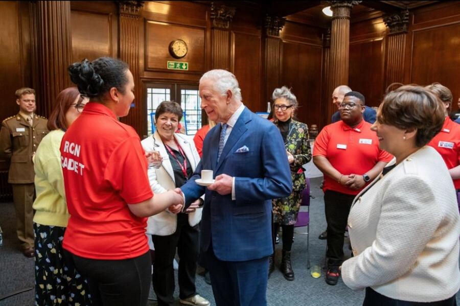 SRC student and RCN Cadet Ambassador Leah Omuvwie shakes hands with King Charles as fellow student and Cadet Ambassador Albert Karomo looks on with other cadets. 