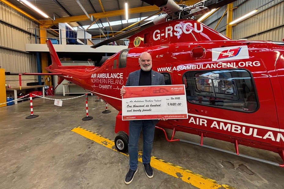 Stefan presents his cheque to Air Ambulance NI