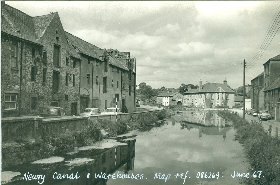 Black and white photograph of Newry Canal and Warehouses, Canal Quay, near Sugar Island, Newry, 1960’s, close to the area where John Roberts Langlands was rescued.  Credit: Newman Collection. Newry & Mourne Museum collection.   