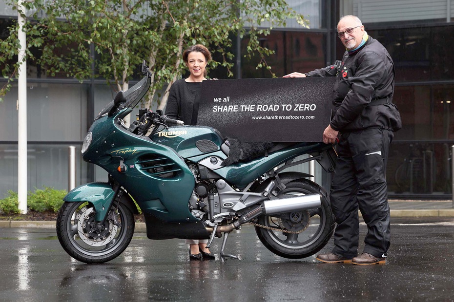 Infrastructure Minister Liz Kimmins with Martyn Boyd as he signs up to Share the Road to Zero community engagement campaign to highlight the dangers for riders on our roads.