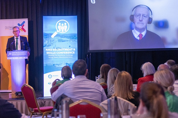 MC, Broadcaster & Journalist, Mark Simpson interviewing Hilary Benn MP, Secretary of State for NI who joined the conference via video-link from Westminster.