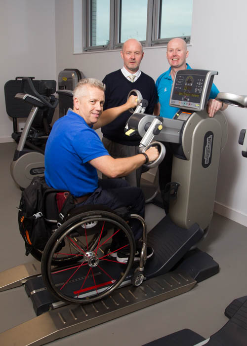 Newry Leisure Centre Duty Manager, David Graham and Fitness Adviser John O'Hare demonstrate the new gym equipment to Aubrey Bingham from Disability Sport NI. Newry Leisure Centre Duty Manager, David Graham and Fitness Adviser John O'Hare demonstrate the new gym equipment to Aubrey Bingham from Disability Sport NI.