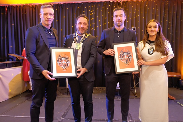 Newry, Mourne and Down District Council Chairperson, Councillor Pete Byrne and Lord Mayor of Armagh, Banbridge and Craigavon Borough Council, Councillor Sarah Duffy presenting the Manager of Armagh GAA, Kieran McGeeney and Captain Aidan Forker with a specially commissioned photograph. 