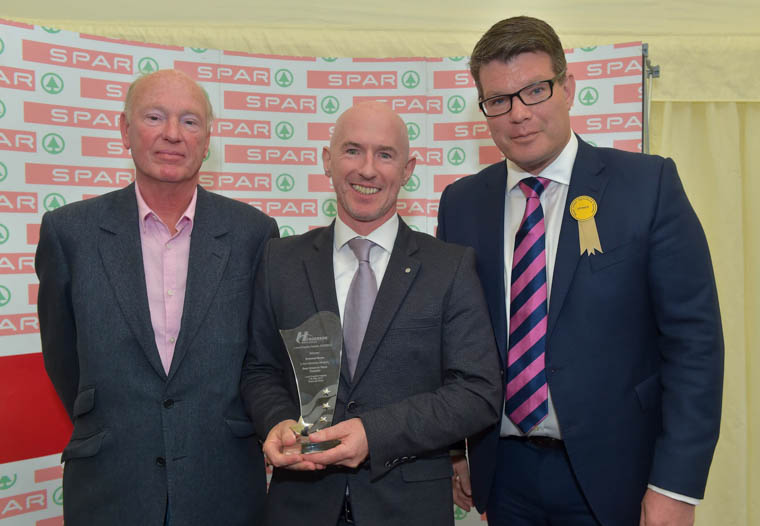Philip Morgan from Around Noon is pictured accepting the Best Direct to Store Supplier Award at the annual Henderson Wholesale Local Supplier Awards, which took place at the Balmoral Show. Pictured presenting the award is agri-business journalist and judge of the awards, Sam Butler (left) with Neal Kelly (right), Fresh Foods Director at Henderson Wholesale.