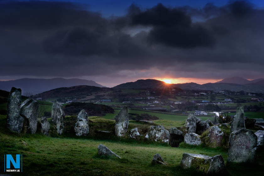 The sun rises behind Ballymacdermot Court Tomb near Newry. The three chambered burial chamber can be dated to at least 2500BC. Photograph: Columba O'Hare/ www.newry.ie