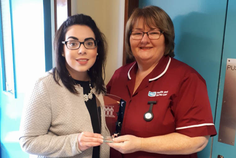 Patient Grace Lynam presents Bernie Trainor Stoma/Coloproctology Nurse for the Southern Trust area with her ‘Patient’s Choice’ Award from the charity ‘Lets Talk Crohn’s and Colitis Association. Patient Grace Lynam presents Bernie Trainor Stoma/Coloproctology Nurse for the Southern Trust area with her ‘Patient’s Choice’ Award from the charity ‘Lets Talk Crohn’s and Colitis Association.
