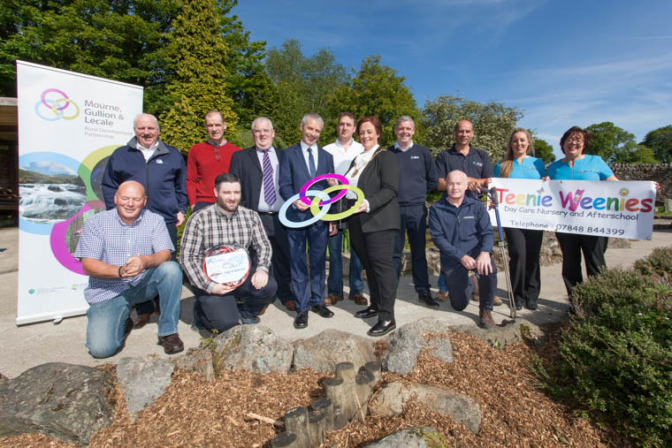 Mourne Gullion and Lecale Rural Development Partnership Local Action Group Chair Nicholas McCrickard is joined by, Councillor Gillian Fitzpatrick, Chairperson of Newry, Mourne and Down District Council, Jerome Burns and Lisa Clydesdale from the Department of Agriculture, Environment and Rural Affairs, Local Action Group members and successful applicants in receiving a Letter of Offer for grant assistance.  Back Row, Left to Right: Seamus Meegan, APS Autoparts Ltd, Councillor Terry Hearty, Local Action Group Vice Chair, Jerome Burns, Department of Agriculture, Environment and Rural Affairs, Nicholas McCrickard, Local Action Group Chair, PJ Burns, James Alexander Engineering Ltd, Colin Gribbon, Viltra, Barry Tinnelly, Tergo Solutions, Sheila Quinn and Katrina McKeown, Teenie Weenies Daycare Nursey and Afterschool. Front Rown, Left to Right: Leo Magee, Leak Detector Ltd, Sean Meegan, APS Autoparts Ltd, Councillor Gillian Fitzpatrick, Chairperson Newry, Mourne and Down District Council.