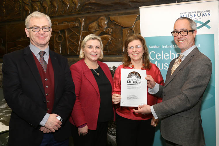 Pictured with the accreditation award are from left: Dr. Ken Abraham (Newry and Mourne Museum), Sinead McCartan (Northern Ireland Museums Council), Noreen Cunningham (Newry and Mourne Museum), and Hadrian Ellory-van Dekker (Chair of the Accreditation Committee)