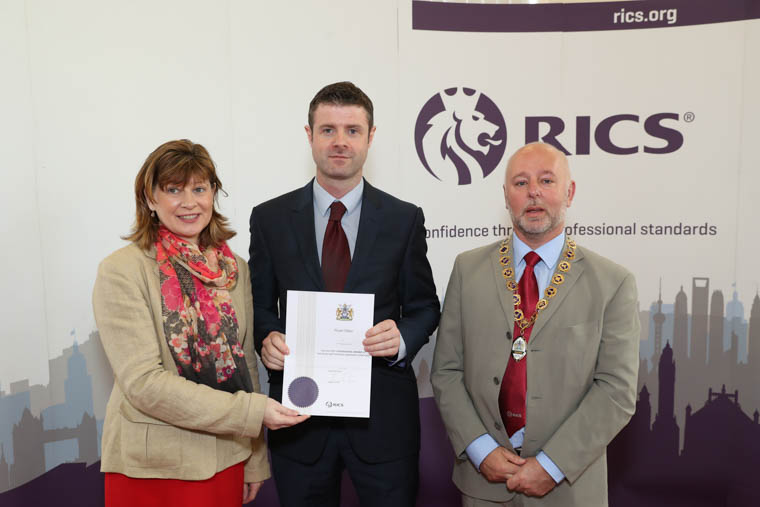 Ruairi Miller from Newry, a newly qualified member of RICS is pictured receiving his diploma from Fiona Grant, RICS UK & Ireland Chair and Andy Tough FRICS, Chair RICS Northern Ireland.
