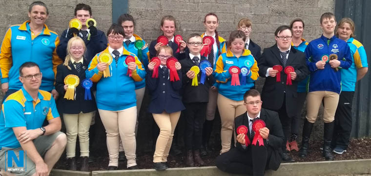Members of Saddle & Reins Special Olympics Equestrian Club with their rosettes.