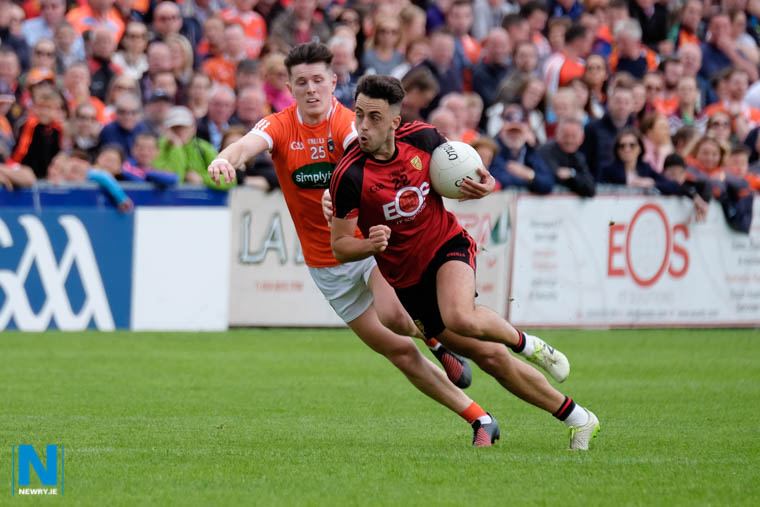 Down's Ryan Johnston on the ball with Armagh's Joe McElroy in pursuit. Photograph: Columba O'Hare