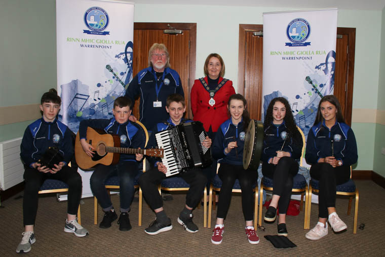 Newry, Mourne and Down District Council Chairperson, Councillor Roisin Mulgrew with Warrenpoint Comhaltas Branch Chairperson, Jimi Quinn and young musicians who will be on their way to North Carolina, US, as part of a visit to promote tourism, trade and cultural exchange. Photograph: Ged McKinley.