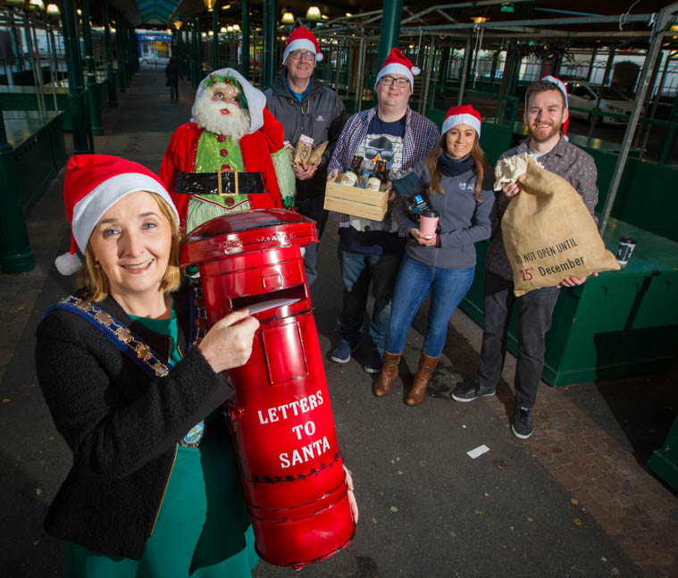 Cllr Roisin Mulgrew, Chairperson, Newry, Mourne and Down Council with stallholders getting ready for the Christmas Twilight Market. 