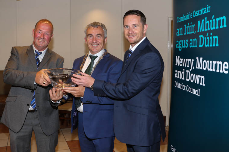 Chairperson Newry City AFC, Martin McLaughlin and Manager, Darren Mullen accept an inscribed bowl from Chairperson Newry, Mourne and Down District Council, Councillor Mark Murnin. Chairperson Newry City AFC, Martin McLaughlin and Manager, Darren Mullen accept an inscribed bowl from Chairperson Newry, Mourne and Down District Council, Councillor Mark Murnin.