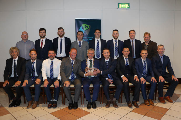 Chairperson Newry, Mourne and Down District Council, Mark Murnin presented Chairperson Newry City AFC Martin McLaughlin, Manager Darren Mullen, Coaches Jervis McCaul, Micky Keenan, Ray Byrne and the Newry City Footballers who took Newry into the Premier League, an inscribed crystal bowl in recognition of their fantastic achievement at a reception hosted by the Chairperson. Councillors Michael Savage and Gary Stokes both spoke at the reception and added their congratulations. Chairperson Newry, Mourne and Down District Council, Mark Murnin presented Chairperson Newry City AFC Martin McLaughlin, Manager Darren Mullen, Coaches Jervis McCaul, Micky Keenan, Ray Byrne and the Newry City Footballers who took Newry into the Premier League, an inscribed crystal bowl in recognition of their fantastic achievement at a reception hosted by the Chairperson. Councillors Michael Savage and Gary Stokes both spoke at the reception and added their congratulations.