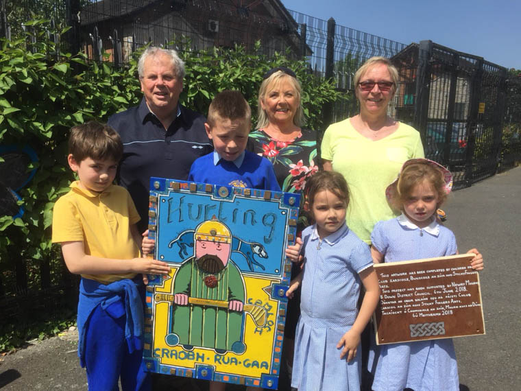 Bronnadh- A Presentation of Children’s Artwork this morning at Bunscoil an Iúir . Pictured are young Craobh Rua players , Lughán, Tommy , Cianna agus Mairéad along with staff from the Bunscoil and Labhrás Bradley who accepted the gift on behalf of Craobh Rua Camlocha Bronnadh- A Presentation of Children’s Artwork this morning at Bunscoil an Iúir . Pictured are young Craobh Rua players , Lughán, Tommy , Cianna agus Mairéad along with staff from the Bunscoil and Labhrás Bradley who accepted the gift on behalf of Craobh Rua Camlocha