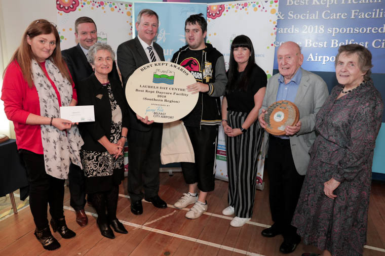 Laurels Day Centre takes home the prize for the Best Kept Health & Social Care Facility in the Daycare category for the Southern Trust. Judges commented on their innovative environmental initiatives, aimed at bringing users and staff together to create a long-lasting and enjoyable place to stay. Pictured at the awards are: Veronica Crossey from Laurels Day Centre, Pauline Lesson, Non-Executive Director of the Southern Trust, Stephen Patton, HR and Corporate Responsibility Manager at George Best Belfast City Airport, Richard Pengelly, Permanent Secretary for the Department of Health, Eamon Louglin and Lisa Doran from Laurels Day Centre, and Doreen Muskett, President of the NI Amenity Council. Laurels Day Centre takes home the prize for the Best Kept Health & Social Care Facility in the Daycare category for the Southern Trust. Judges commented on their innovative environmental initiatives, aimed at bringing users and staff together to create a long-lasting and enjoyable place to stay. Pictured at the awards are: Veronica Crossey from Laurels Day Centre, Pauline Lesson, Non-Executive Director of the Southern Trust, Stephen Patton, HR and Corporate Responsibility Manager at George Best Belfast City Airport, Richard Pengelly, Permanent Secretary for the Department of Health, Eamon Louglin and Lisa Doran from Laurels Day Centre, and Doreen Muskett, President of the NI Amenity Council.