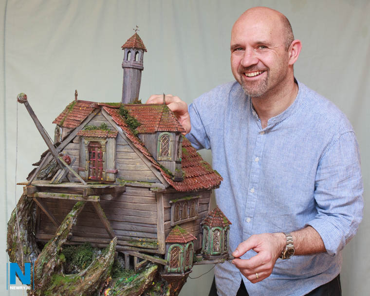Garry McElherron with a model of his MourneQuest creaky old mansion perched on top of a tree that grows within a tree. Photograph: Columba O'Hare/ Newry.ie Garry McElherron with a model of his MourneQuest creaky old mansion perched on top of a tree that grows within a tree. Photograph: Columba O'Hare/ Newry.ie