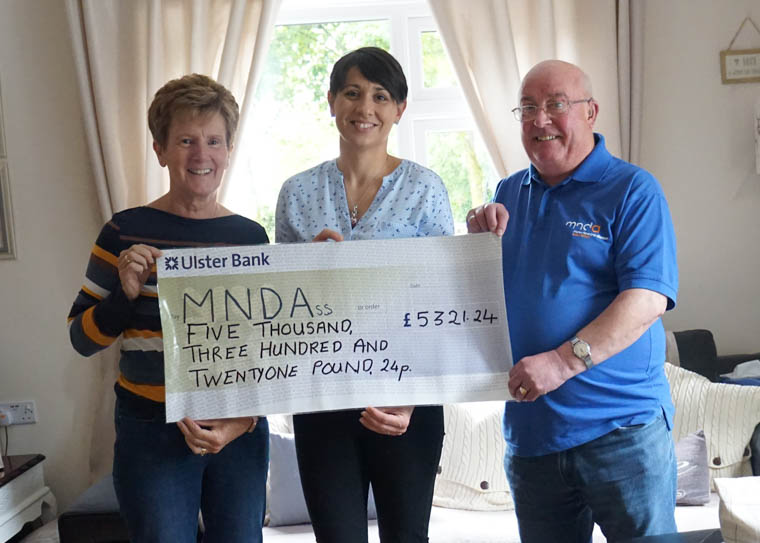Tammy and Anne present a cheque to Tony Carroll of MNDA NI. Tammy and Anne present a cheque to Tony Carroll of MNDA NI.