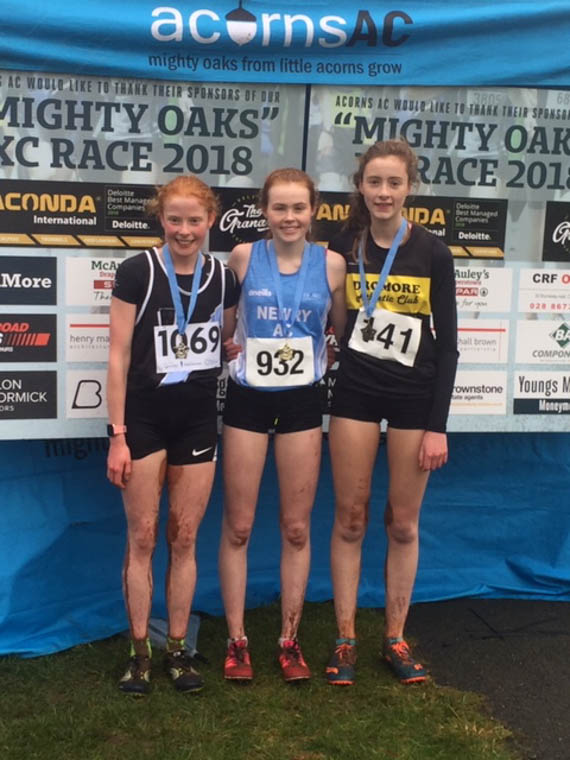 Meadow McCauley (Centre) lifting 1st Place in Mighty Oaks XC U16s race. 