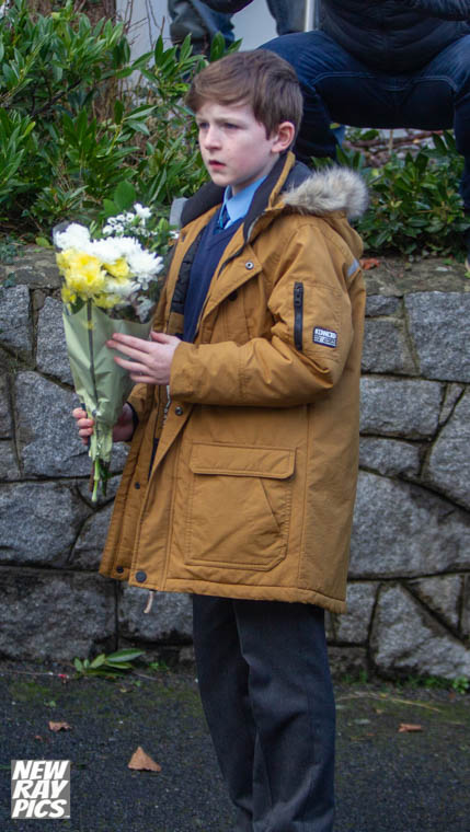 A pupil from Windsor Hill Primary School brings a bunch of flowers to the Glin Ree Court Newry . in tribute to the who died. A pupil from Windsor Hill Primary School brings a bunch of flowers to the Glin Ree Court Newry . in tribute to the who died.