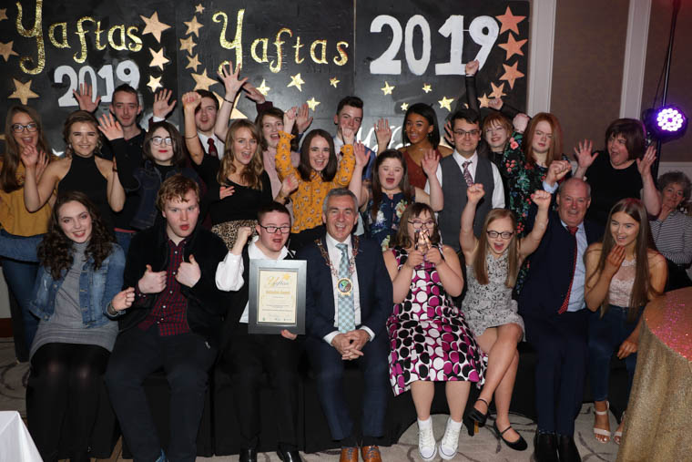 YAFTAS Inclusion Award Winners Wonder Youth Group and Newry Youth Forum accepted their award from Sponsors Equality Office  Newry, Mourne and Down Council represented by CEO Liam Hannaway and Chairman Councillor Mark Murnin. Youth Workers Ruth Neary, Pauline McQuillan, Ryan Crilly joined the group in their celebrations. Wonder Youth Group is a group of young people aged 16+ with disabilities and learning needs from Newry and Mourne. They are a participative structure who aims to provide opportunities for others. They want to be recognised for being positive role models and highlight the achievements of those with disabilities. Together with Newry Youth Forum the groups organised a formal on the 8th February for young people with disabilities living in the Newry & Mourne area. The event was attended by over 70 young people, the two groups worked tirelessly together to ensure that every aspect of the night was tasteful, age appropriate and that everyone attending felt special. The night was a huge success and all are to be commended to not allowing disability from creating a truly magicial evening for other young people who are socially excluded and marginalised for their disabilities and learning needs.