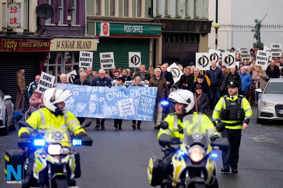 A 50th Anniversary commemoration of the Newry Civil Rights Parade passes through Sugar Island in Newry on Sunday. The original parade on 11th of January 1969 organised by People's Democracy was banned from passing through the area. Photograph: Columba O'Hare/ Newry.ie