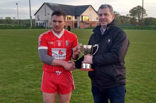 Michael &Oacute; &lsquo;Gairbhith  receives the Colm Geary Cup from Louth Chairperson Des Halpenny